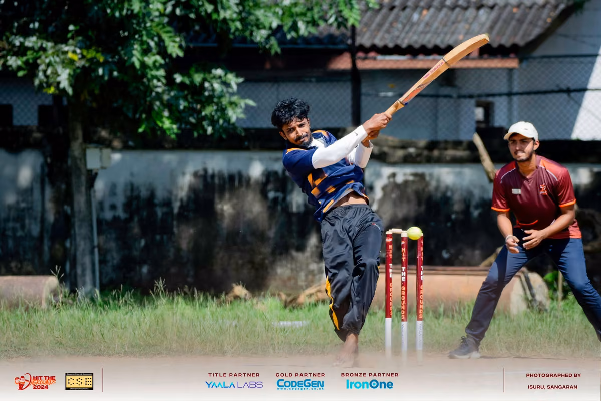 A batter swinging at the crease