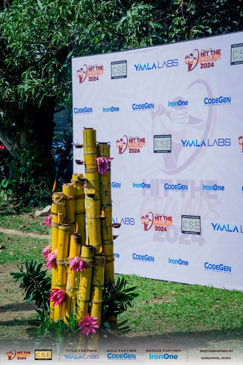 Bamboo decoration beside a sponsor backdrop