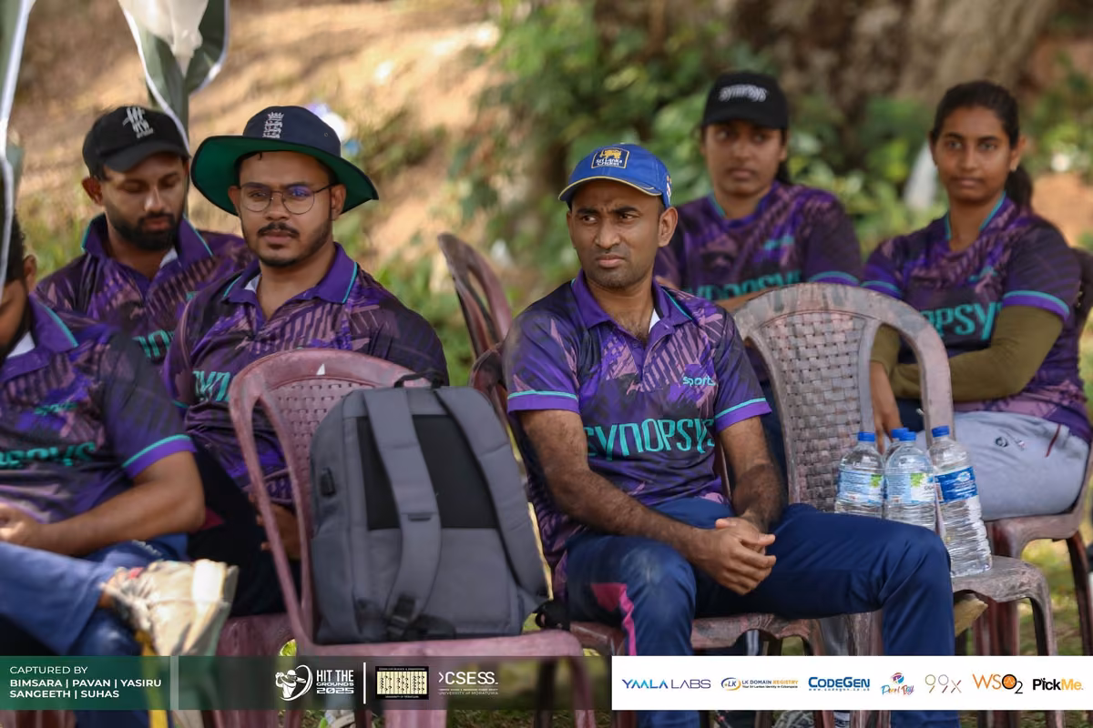 Players in purple jerseys on the sidelines