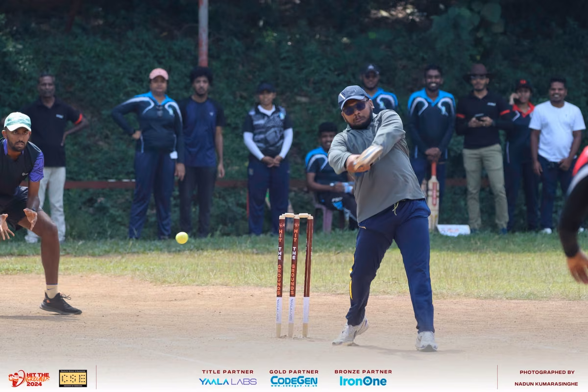 A batter at the crease with spectators behind the stumps