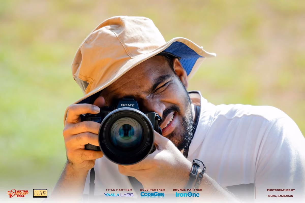 A photographer in a bucket hat lining up a shot