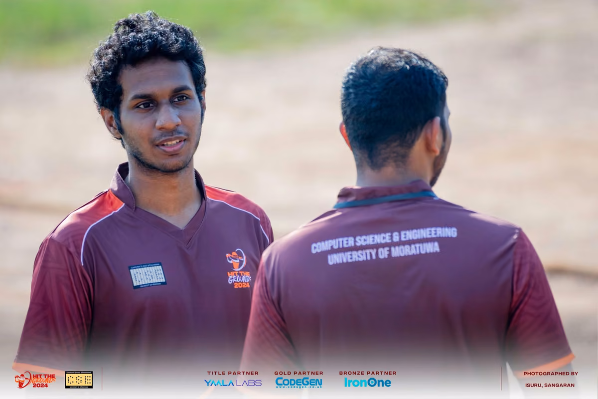 Two players in maroon University of Moratuwa shirts