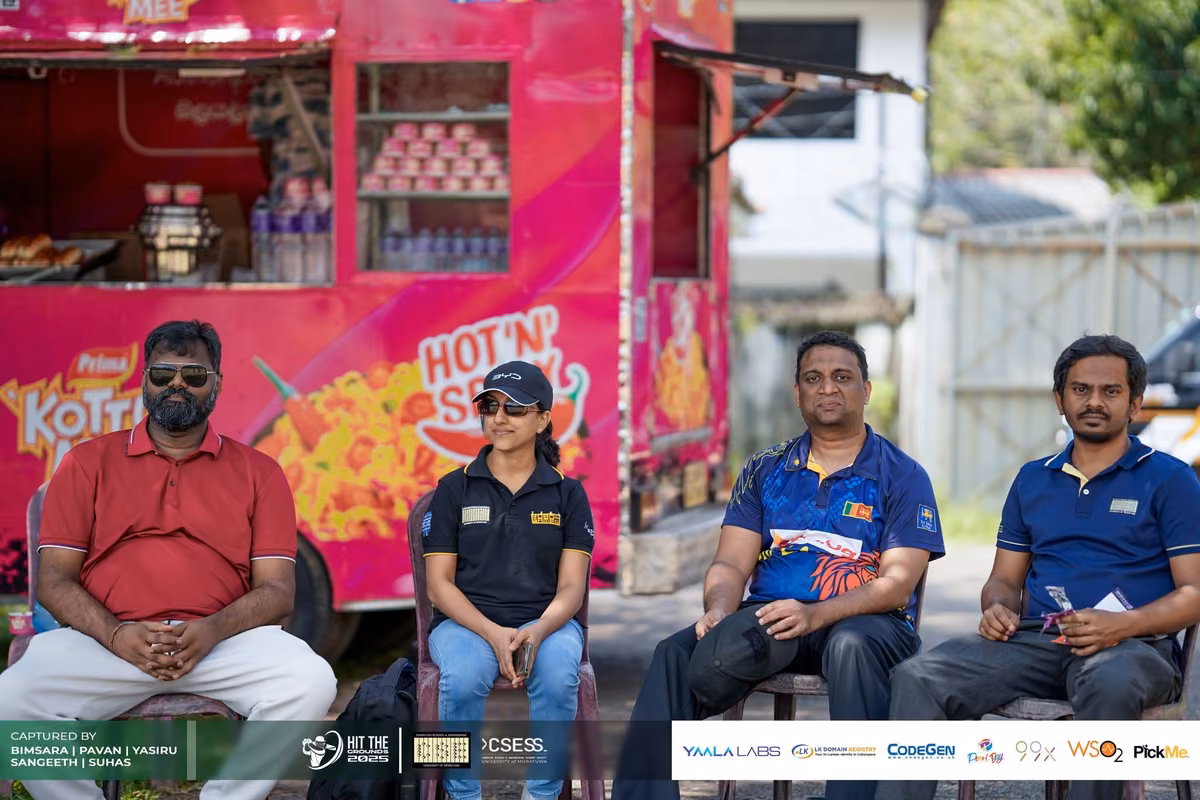 Players and a supporter in front of a pink food truck