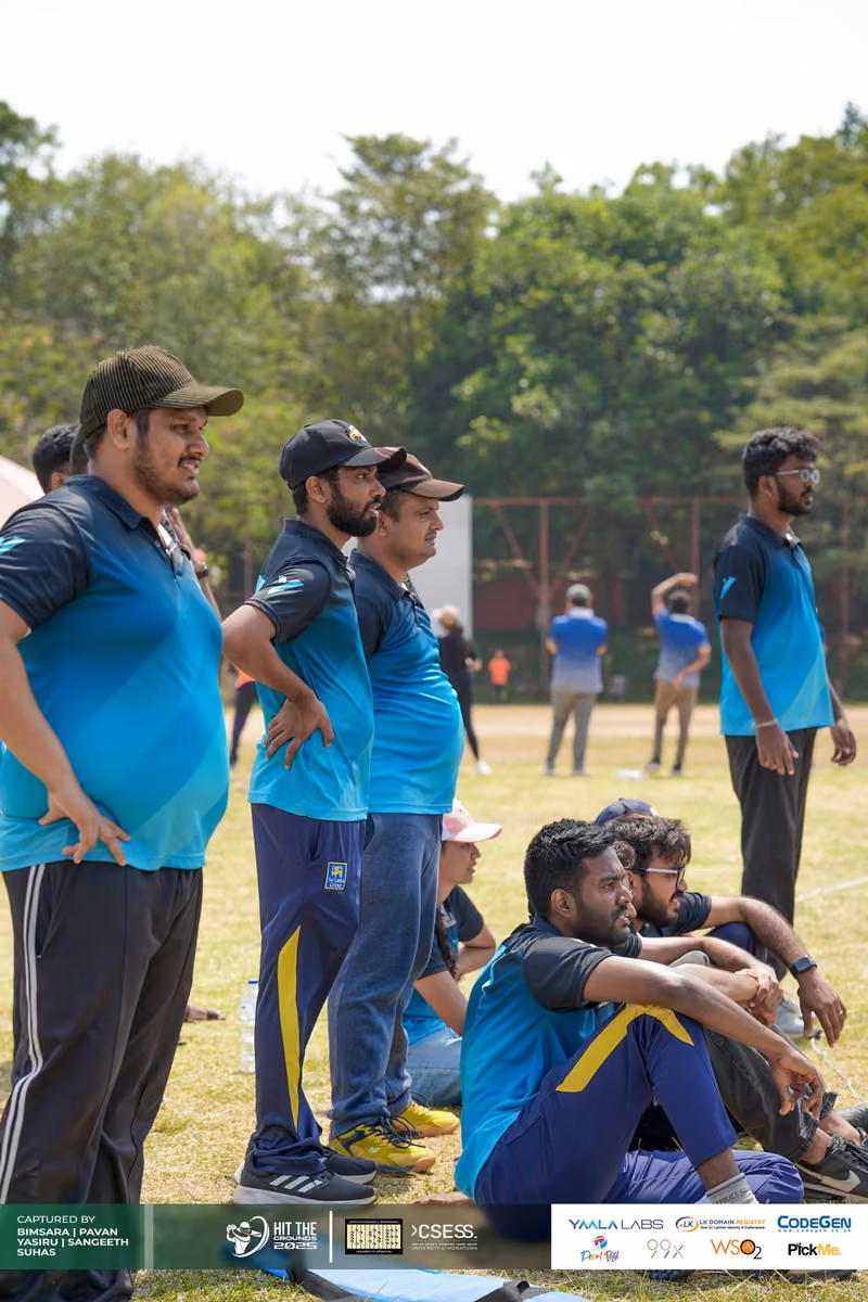 Players in teal jerseys resting by the boundary