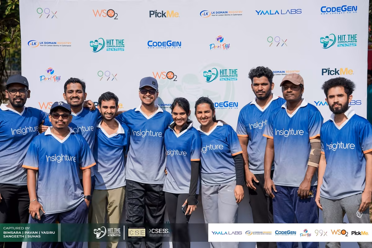 A team in blue gradient jerseys in front of the sponsor backdrop